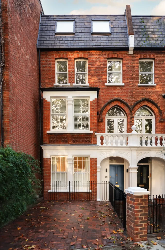 London house exterior in Fulham Broadway with red brick facade, bay windows and period detailing