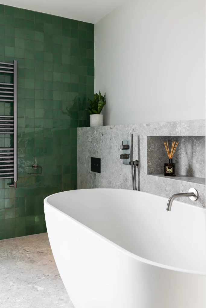 Modern London bathroom with freestanding bath, green tiles and minimalist design details