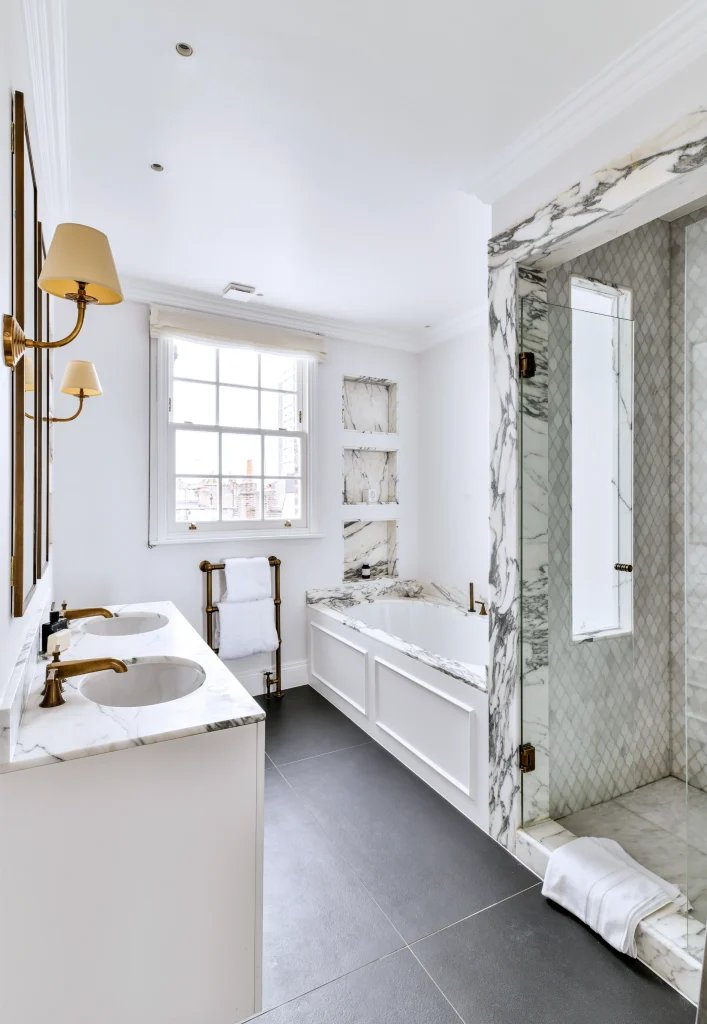 Modern Kensington bathroom: bespoke white vanity, marble splashback, and luxury glass shower enclosure
