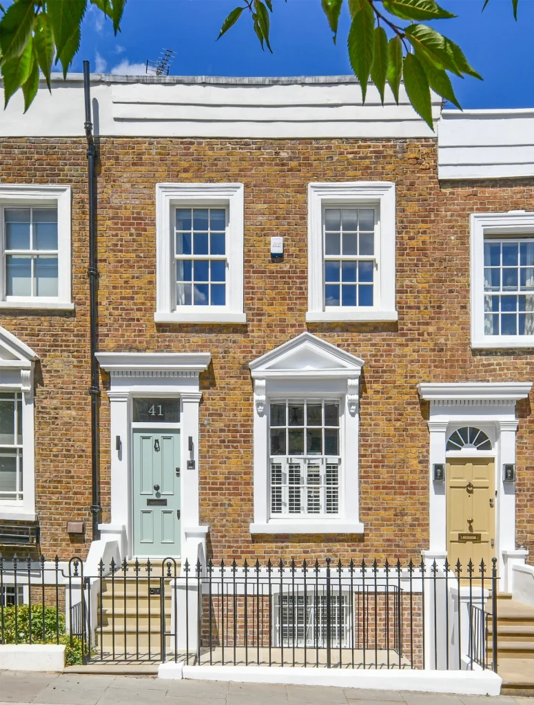 Modern Kensington Period home exterior featuring traditional brickwork, white masonry, and iron railings