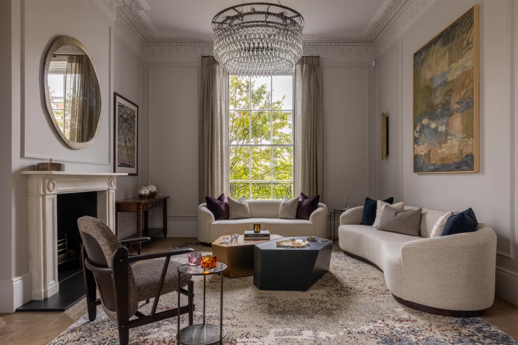 Expert coffee table styling featuring sculptural objects and layered books in a luxury London living room