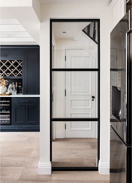 London residential architecture with steel-framed glass door, bespoke joinery and contemporary interior detailing