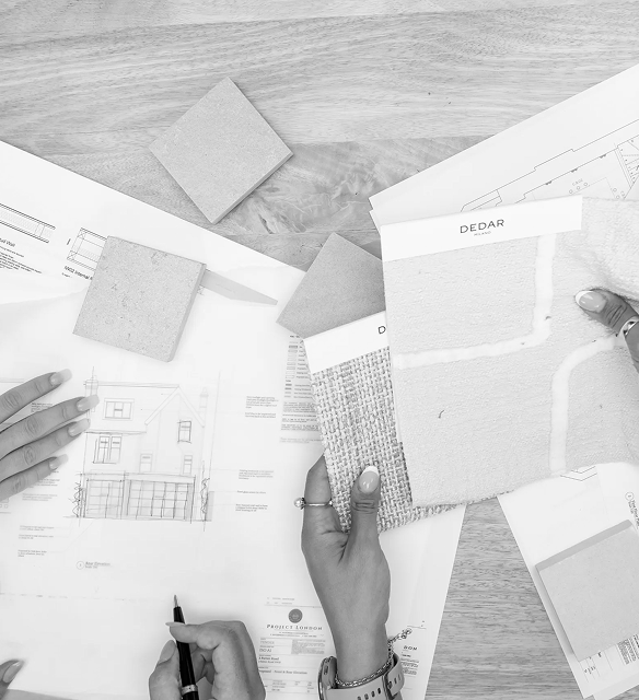 Interior design and architecture London team working with material samples, plans and design concepts