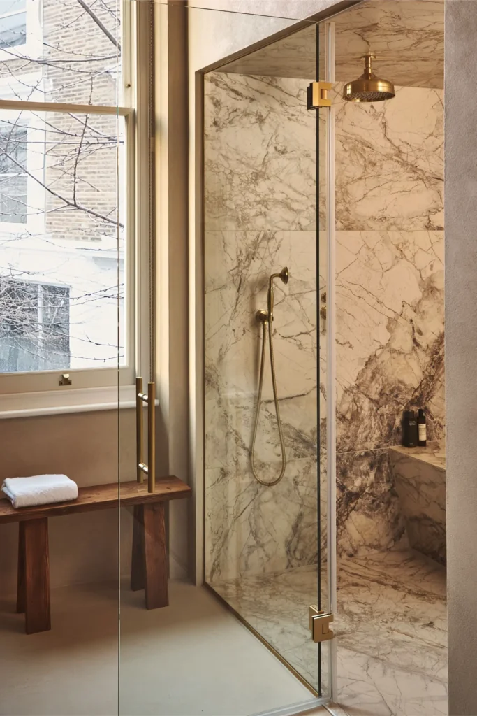 Portobello Road London bathroom with marble walk-in shower, glass enclosure and brass fixtures