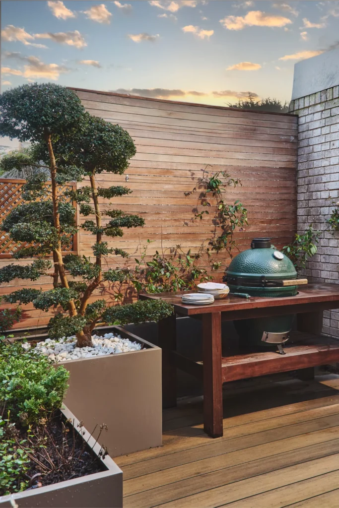 Luxury outdoor terrace in Portobello Road London with wooden deck, barbecue station and garden plants