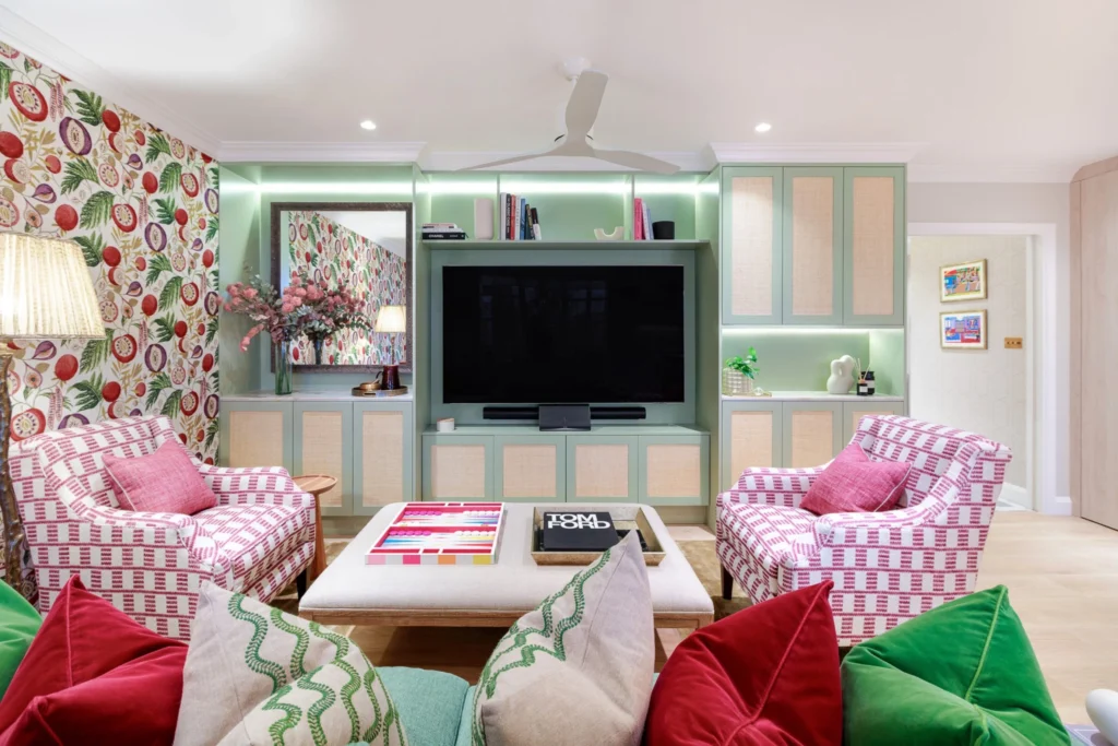 Modern living room: custom mint green TV unit, integrated LED lighting, and fruit motif feature wall