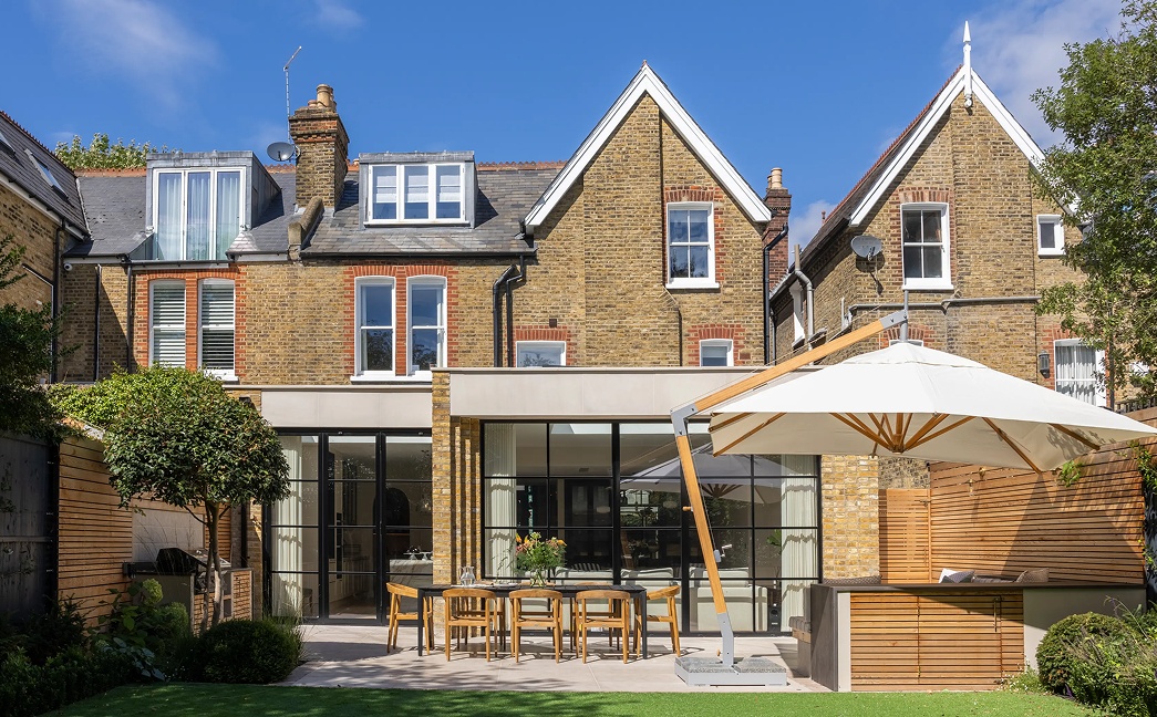 High-end residential architecture London showcasing brick townhouse extension and modern glazed façade